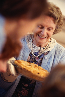 A picture of a grandma with a pie.
