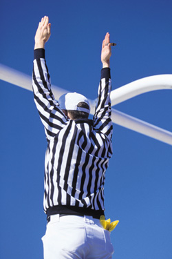 A referee making a touchdown call.