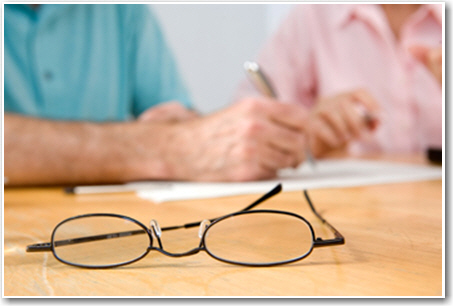 Two individuals revising a paper.
