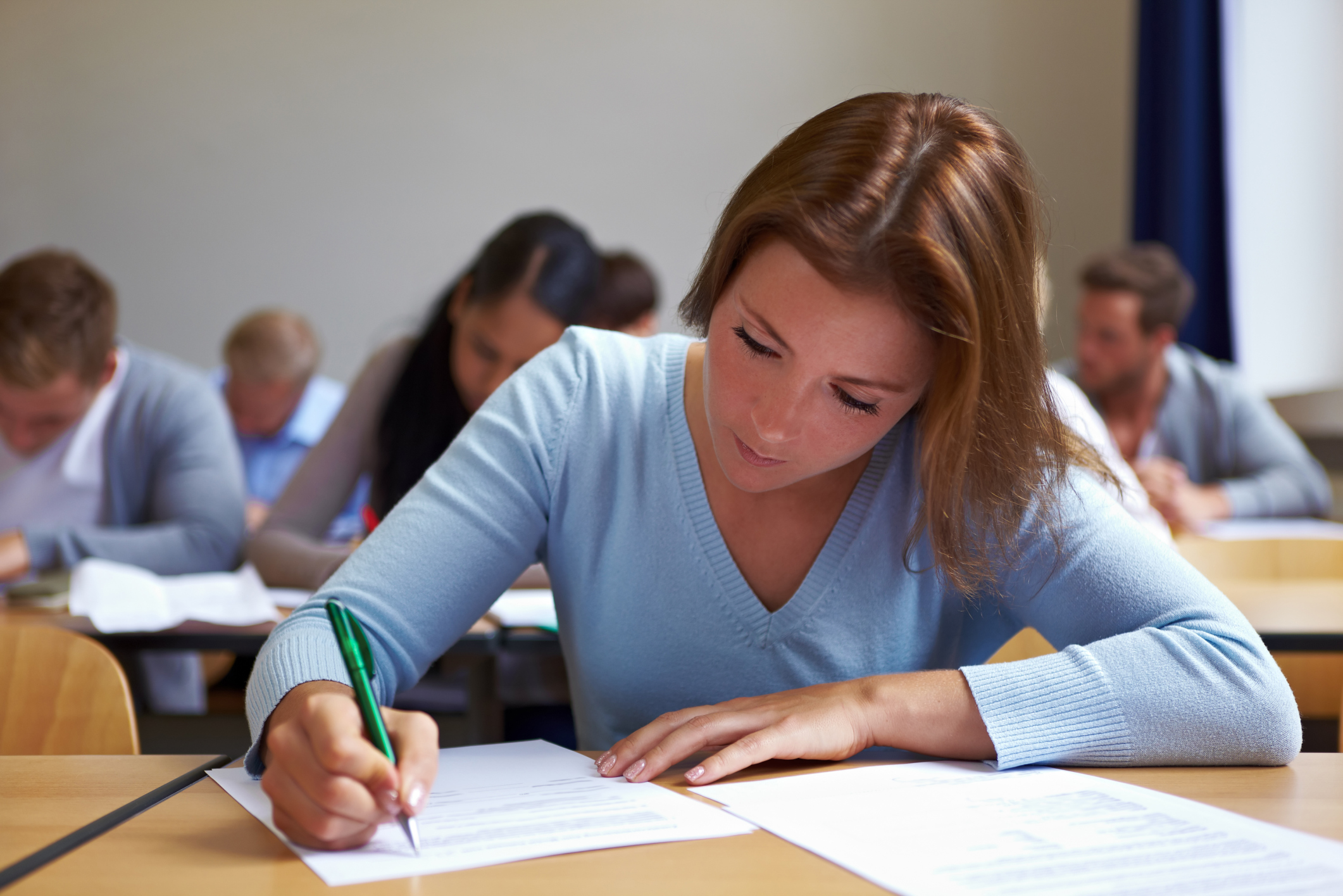 women in a blue sweater working on an assignment