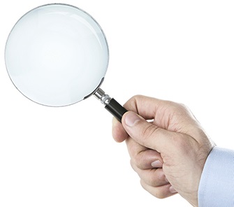 A person holding a magnifying glass.